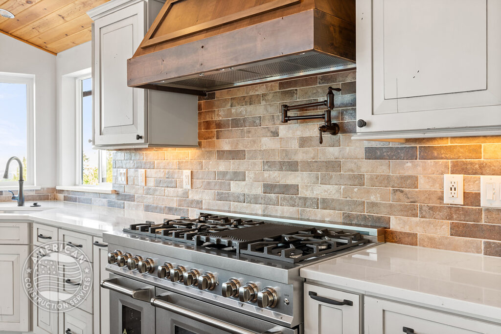 Stainless steel range and oven with attractive backsplash and pot filler, kitchen remodeled by American Construction Services, Corp.