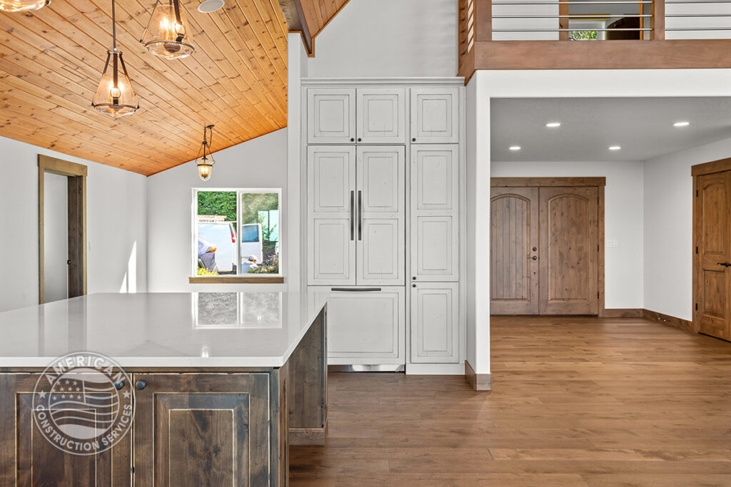 Integrated refrigerator blends seamlessly in kitchen remodeled by American Construction Services, Corp.