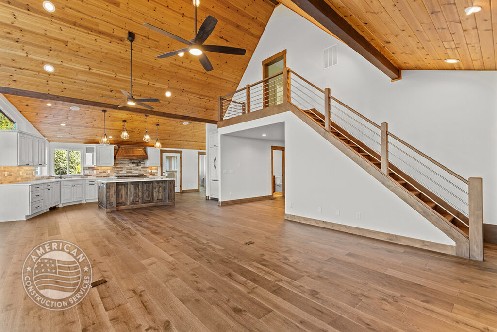 Vaulted great room with hardwood wood floors, remodeled by American Construction Services, Corp.