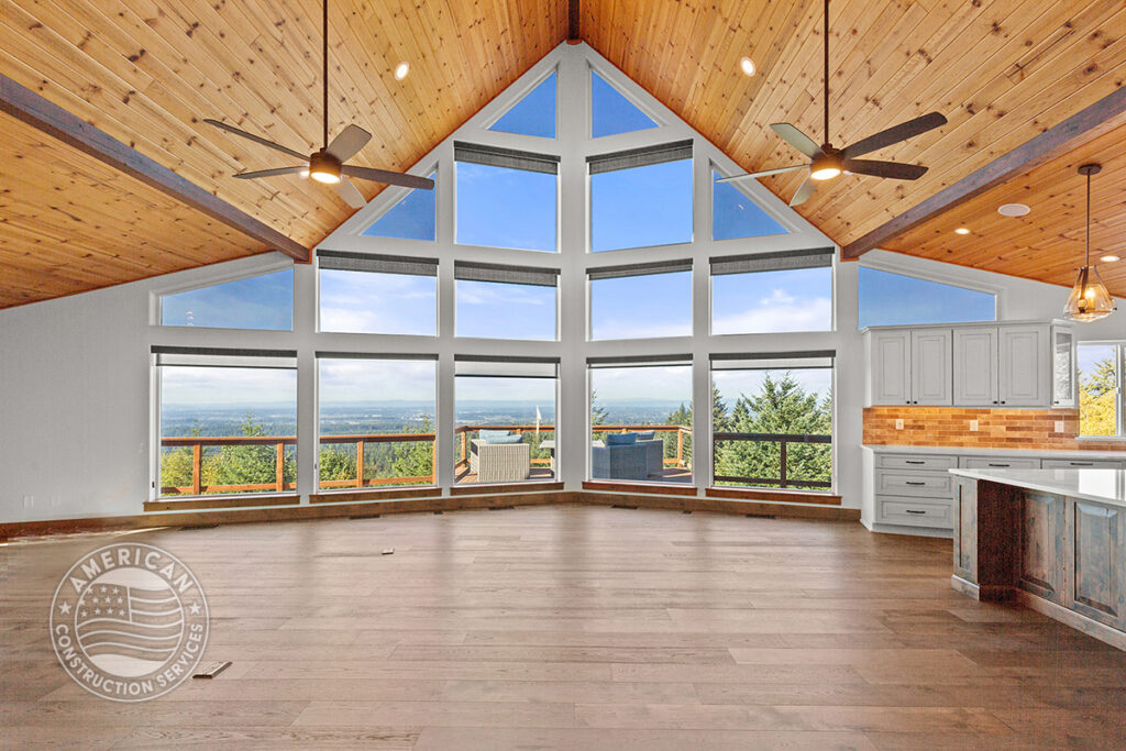 Vaulted wood beam ceiling and wall of windows by American Construction Services, Corp.