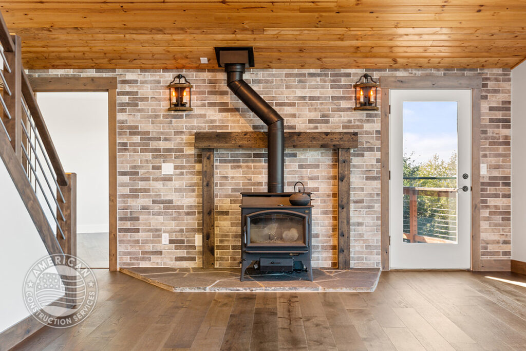 Fireplace with stone surround in great room, remodeled by American Construction Services, Corp.