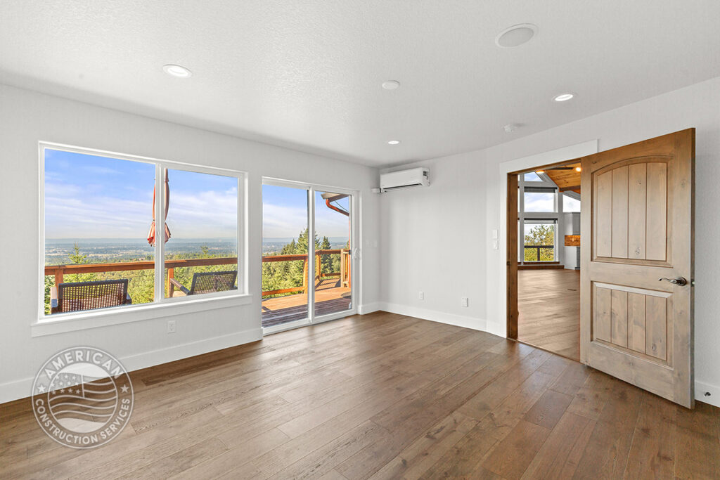 Bedroom with sliding doors to deck, remodeled by American Construction Services, Corp.