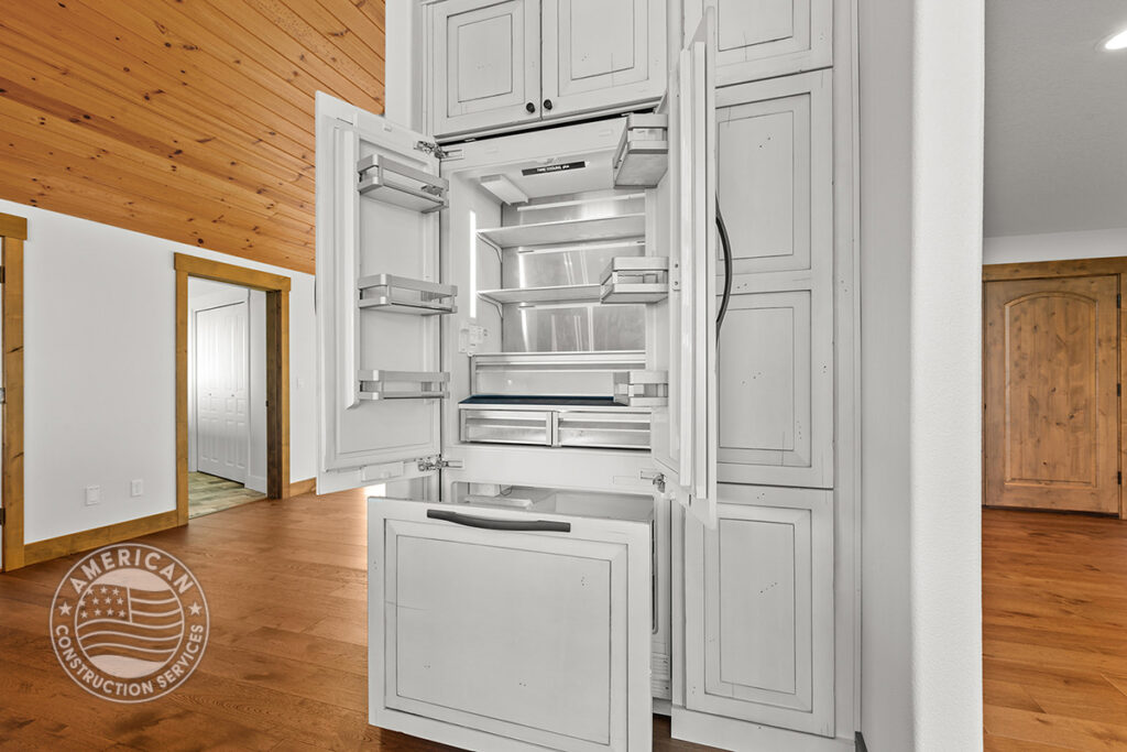 Integrated refrigerator blends seamlessly in kitchen remodeled by American Construction Services, Corp.