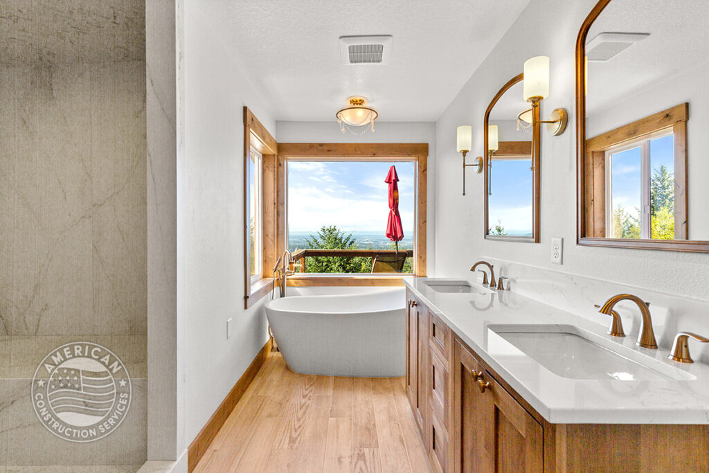 Soaking tub, shower, double vanities in primary bathroom remodeled by American Construction Services, Corp.