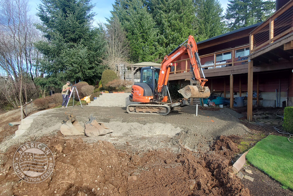 American Construction Services Corp Site prep for a swim spa. Includes dirt work, retaining wall, underground electrical, heavy pad with rebar.